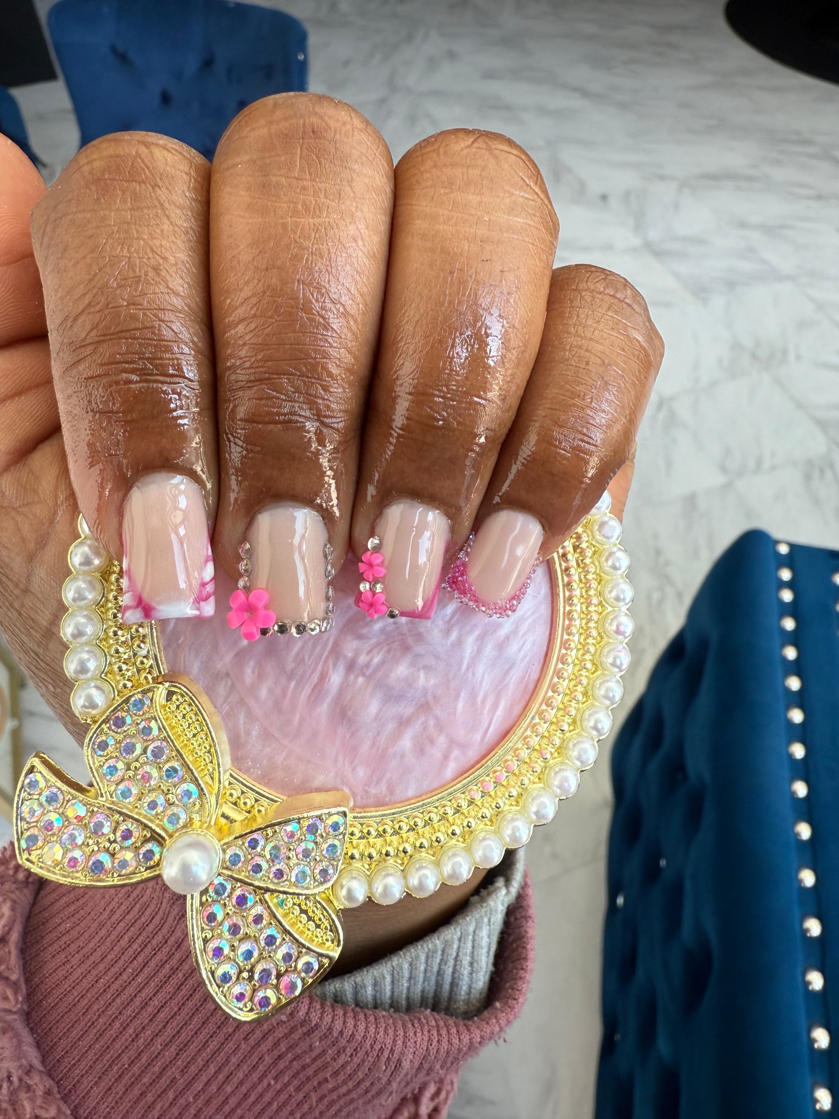 Nude and pink nails with rhinestone and floral accents