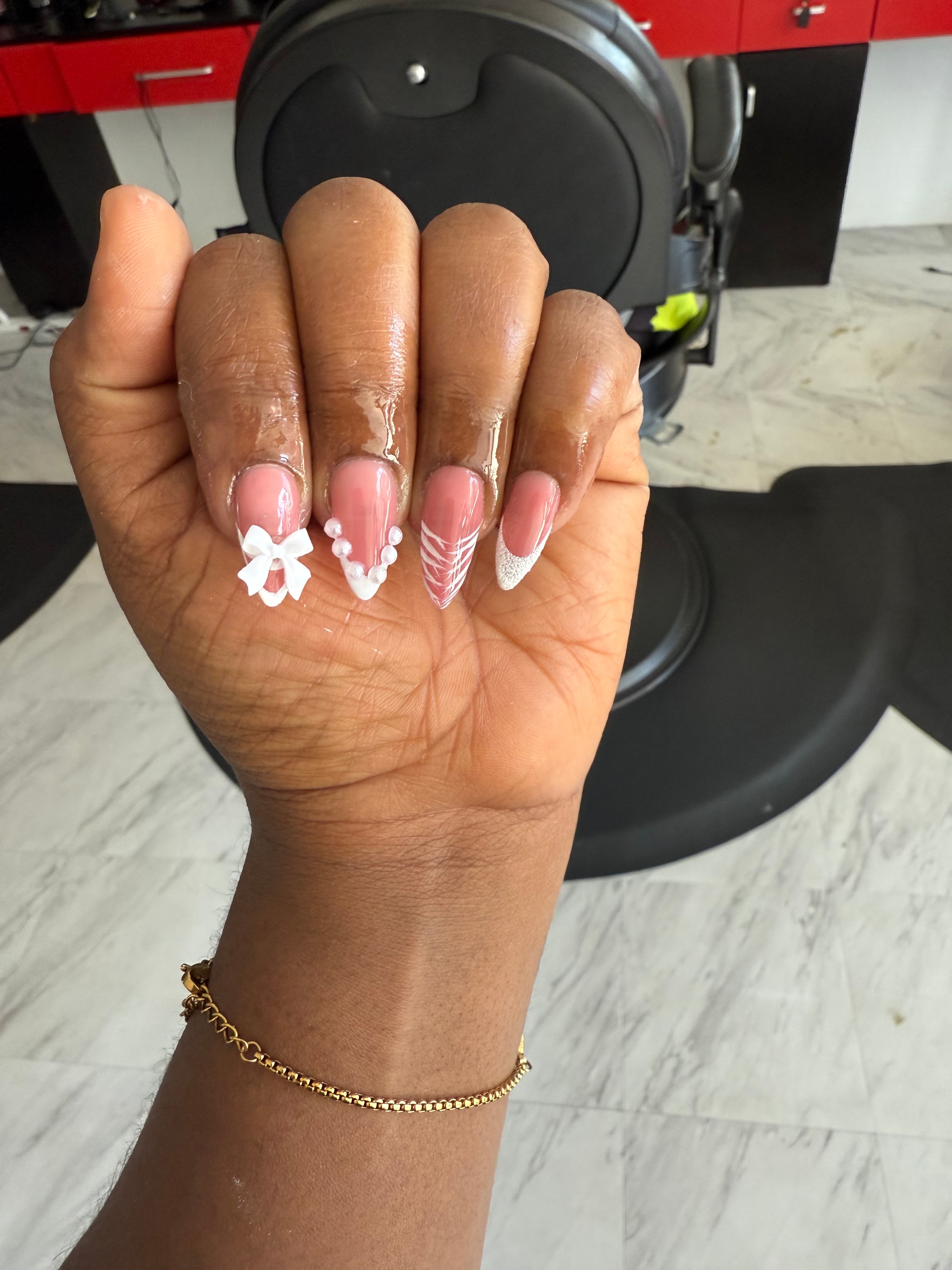 Pink nails with pearl bow and white floral nail art